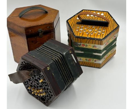 A 19thC hexagonal concertina with rosewood ends, fretwork panels, 5 bellows, 20 bone buttons and two leather straps in origin