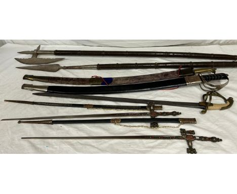 Swords to include: 2 x Indian ceremonial swords with curved blades, etched decoration and pierced guards both in original sca
