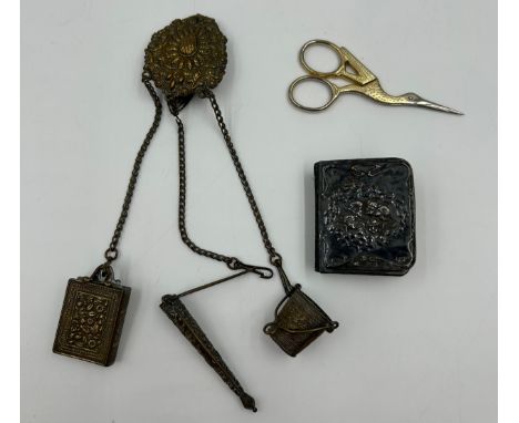 A silver mounted prayer book, decorated with cherubs, Birmingham 1914, G &amp; C Ltd together with a metal chatelaine and sma