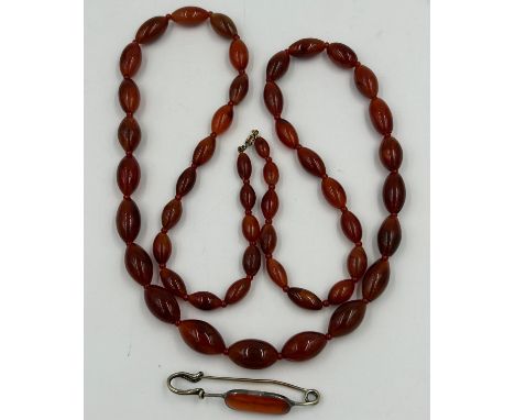 Good quality vintage amber coloured glass beads, 60cm together with a white metal  kilt pin with amber coloured stone.