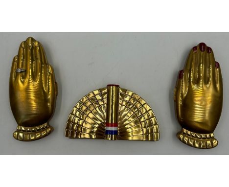 Two Volupte "Golden Gesture" powder compacts in the form of two hands, one with red painted nails and the other with a paste 