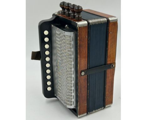 A Mahogany Cajun 4-stop Melodeon with 16 bellows with metal edges, 3 metal stops to the side, 4 wooden stops to the top, 10 t
