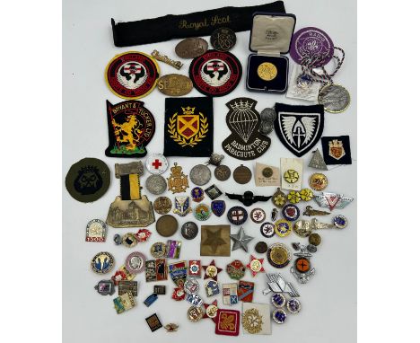 An assortment of badges, sew on patches, buttons, medallions etc. to include railway, Orient Express, girl guides, football, 