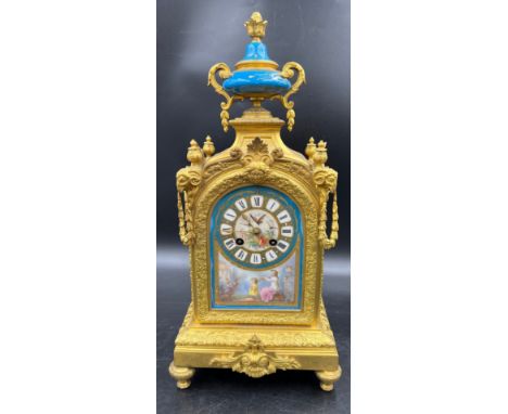 A 19thC French gilt metal and porcelain mantle clock, striking on a bell. 42cm h. Marked to works Wartenberg Paris. With key.