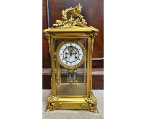 A fine quality gilt bronze mantel clock probably French with visible Brocot escapement, the 8 day movement striking on a gong
