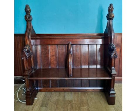 A two seater oak pew originally from Hull Minster with detailed figural carvings. 152cm h x 134cm w x 50cm d.