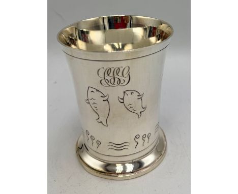 A silver cup with fish decoration. Birmingham 1935 with Jubilee mark, maker Adie Brothers Ltd. 7cm h. Weight 110gm.