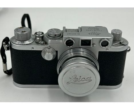 A Leica D.R.P Ernst Leitz Wetzlar camera No.597487 with Leitz Wetzlar GmbH lens together with a Lowepro camera bag.