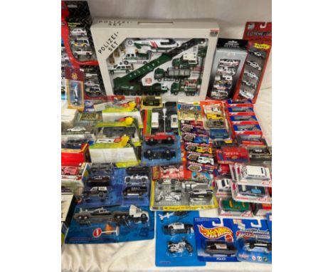 A collection of diecast vehicles in playsets to include Polizei-set by Autocraft, Chad Valley, Robocop, Realtoy, Majorette an