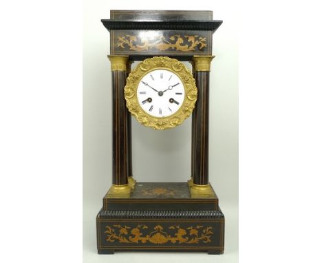 A French, Napoleon III period, portico mantel clock, enamel dial bearing Roman numerals, eight day twin barrel movement, half