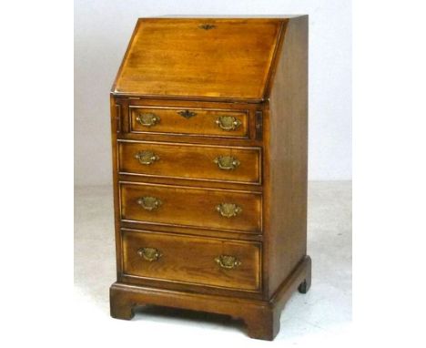 A reproduction George III style oak bureau, with fitted interior, fall front and four graduated drawers, raised on bracket fe