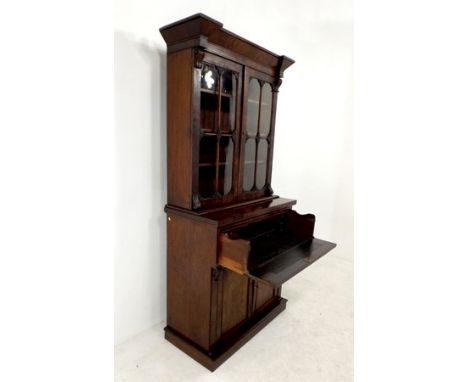 An early Victorian mahogany secretaire bookcase, the outswept and stepped cornice over two astragal glazed doors, opening to 