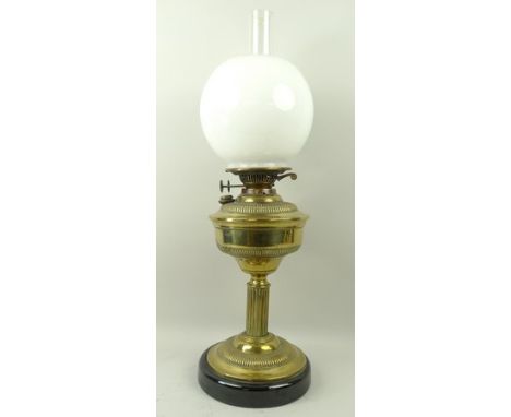 A Victorian brass column oil lamp with brass reservoir and opaque glass shade, 63cm high. 