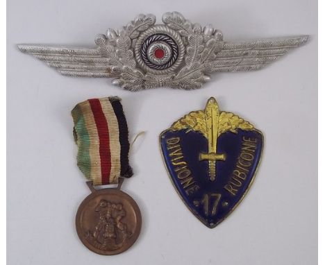 A Luftwaffe officer's cap badge, WWII German/Italian North Africa Medal, and an enamel shield badge for the Italian 17th Divi