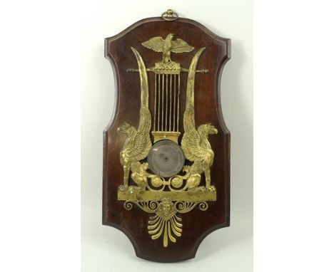 A 19th century French wall barometer, having ormolu figures of Griffin caryatids surmounted by an eagle, silvered dial, with 