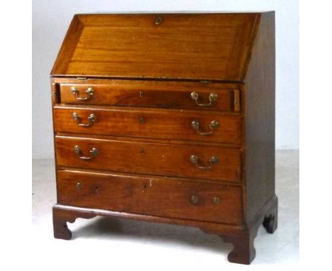 A George III mahogany and oak bureau, the fall front enclosing a fitted interior, four graduated drawers and raised on bracke
