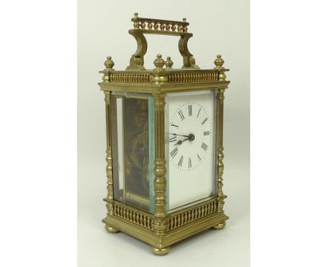 A brass cased carriage clock, late 19th century, of architectural form, enamel dial bearing Roman numerals, Swiss movement, 7