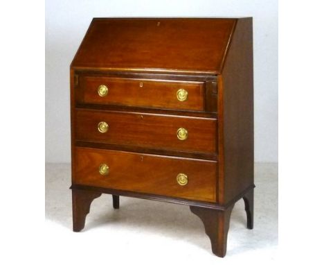 An Edwardian mahogany bureau, the fall flap enclosing a drawer and recesses, above three long graduated drawers, raised on br