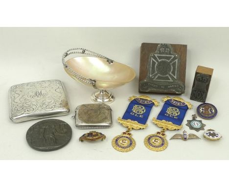 A silver cigarette case engraved with reserve crest and lion supporters, scrolling foliage and monogram, a vesta case, shield