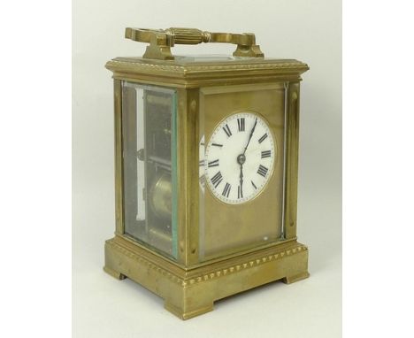 A brass carriage clock, circa 1890, enamel dial bearing Roman numerals, with an English twin barrel movement, 9 by 8 by 12cm.