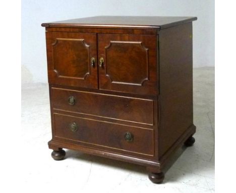 A 19th century mahogany commode, the two doors above dummy drawers, the lid opens to reveal a ceramic bowl, 60 by 51 by 71cm 