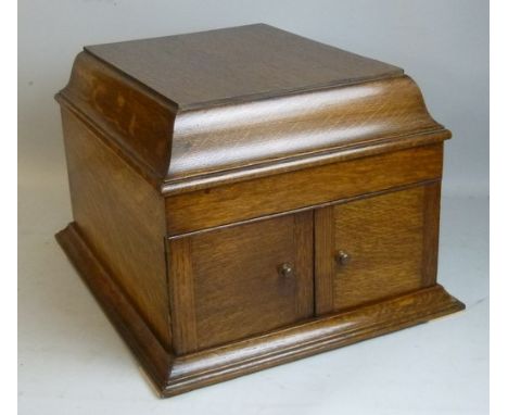 A Zonophone record player in an oak case, with winding handle together with a carrying case with a quantity of 78rpm records,