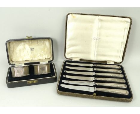 A set of six silver handled fruit knives, Sheffield 1937, boxed, and a pair of silver napkin rings with engine turned decorat