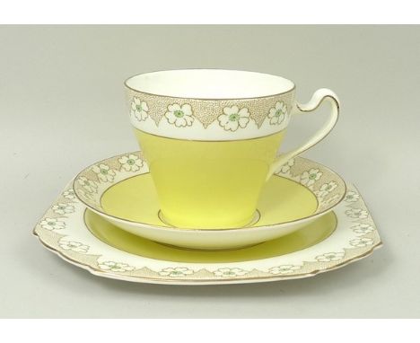 A Heathcote porcelain tea service, decorated with gilded flowers above a yellow ground, comprising; cream jug, sugar bowl, pa