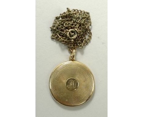 A 15ct gold photograph locket with engine turned decoration, reserve monogram and internal dedication, 9.2g.