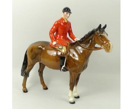 A Beswick figure of a huntsman mounted on a brown gloss horse, 21cm high.