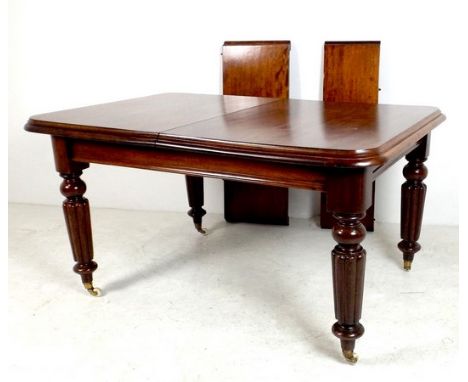 A Victorian mahogany extending dining table, with two additional leaves, the rectangular surface with moulded edge, raised on