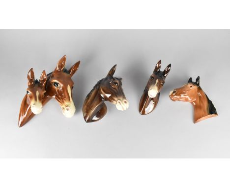 A Collection of Four Various Glazed Ceramic Horse Wall Plaques