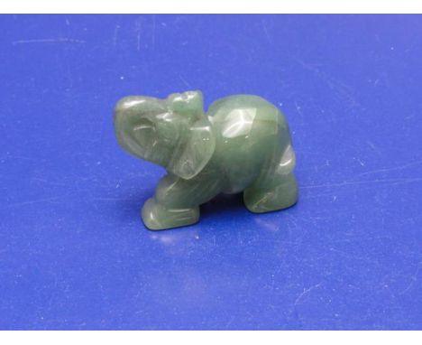 A small carved jade elephant 5cm x 4cm 