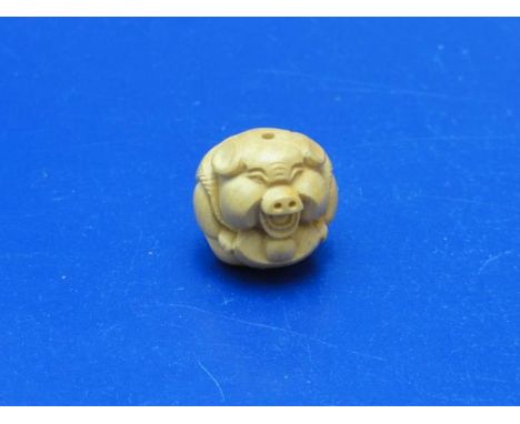 A small carved wooden pig form netsuke 