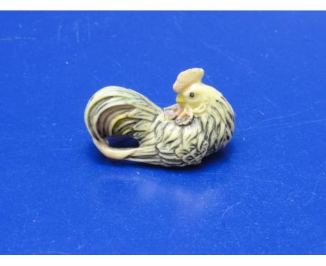 A well carved cockerel form netsuke 