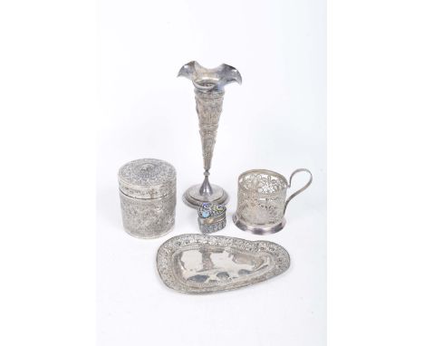 A collection of white metal items
To include an Eastern white metal bud vase embossed with hunting scenes, a canister with re