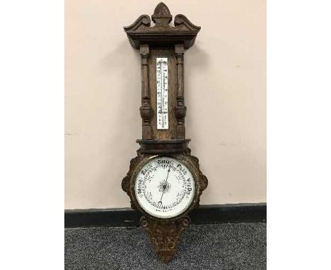 A late nineteenth century carved oak aneroid barometer
