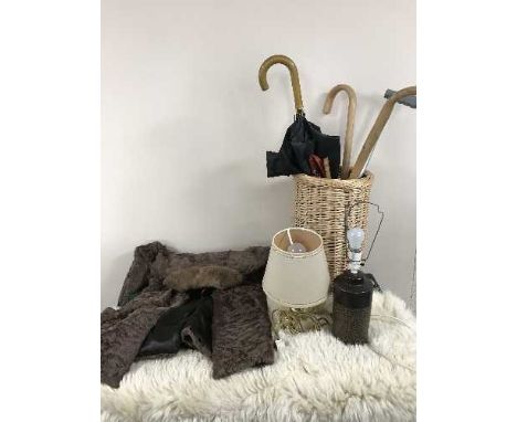 Wicker stick stand, walking sticks and umbrellas, four table lamps and a sheepskin rug 