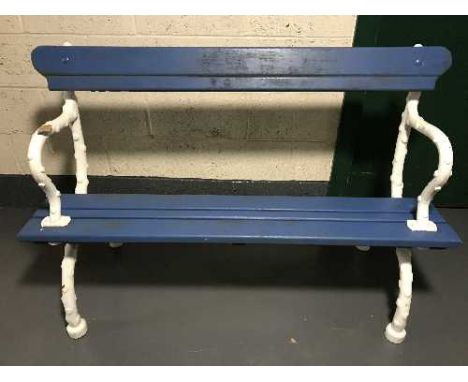 An antique and later garden bench with cast iron ends