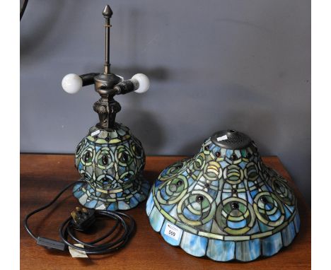 Tiffany style table lamp on a blue ground with abstract decoration. (B.P. 21% + VAT) Light fitting part is detached / broken 