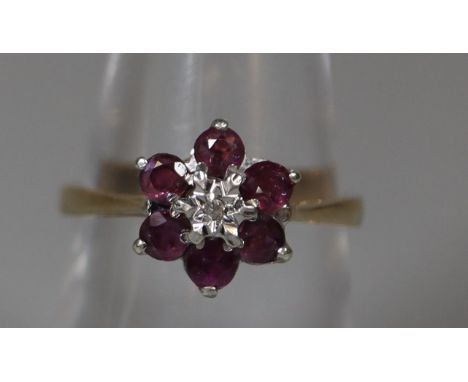 9ct gold ruby and diamond flowerhead cluster ring.  Ring size N.  Approx weight 2.6 grams.(B.P. 21% + VAT) 