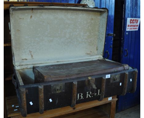Vintage canvas metal and wooden banded travelling trunk, together with a leather vintage travelling trunk, the canvas trunk m