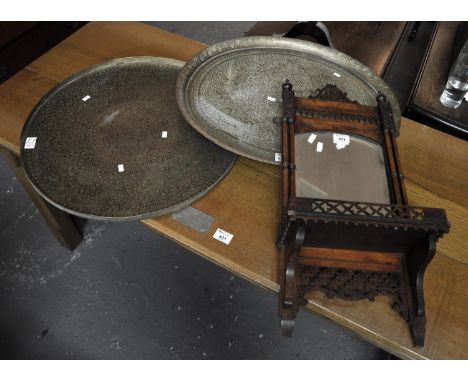 Small Edwardian mahogany pierced wall mirror with under shelf, together with two Indian design brass trays. (3)(B.P. 21% + VA