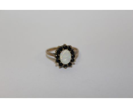 A HALLMARKED 9 CARAT GOLD OPAL SET DRESS RING  APPROX WEIGHT - 2.5G