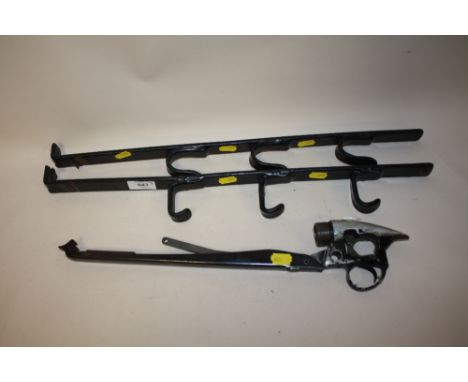 A PAIR OF WALL MOUNTABLE GUN RACKS, TOGETHER WITH AN AIR RIFLE TRIGGER MECHANISM 