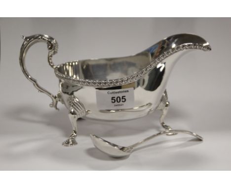 A HALLMARKED SILVER SAUCE BOAT TOGETHER WITH A PLATED LADLE