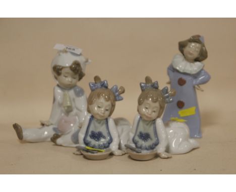 FOUR NAO FIGURES OF YOUNG CHILDREN TO INCLUDE A CHILD IN A COW COSTUME 