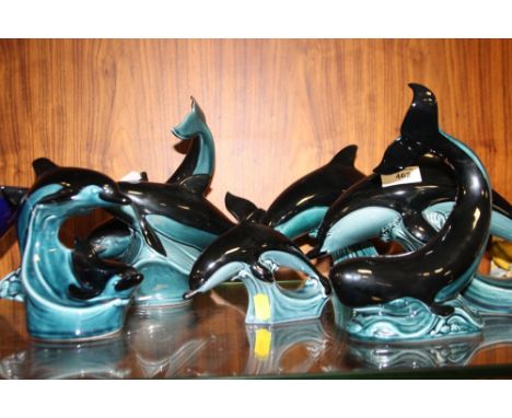 A COLLECTION OF POOLE POTTERY DOLPHIN FIGURES AND A WHALE (6)