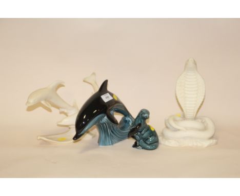 TWO POOLE FIGURES OF AN OTTER AND A DOLPHIN TOGETHER WITH TWO RESIN FIGURES OF A COBRA AND DOLPHINS (4)