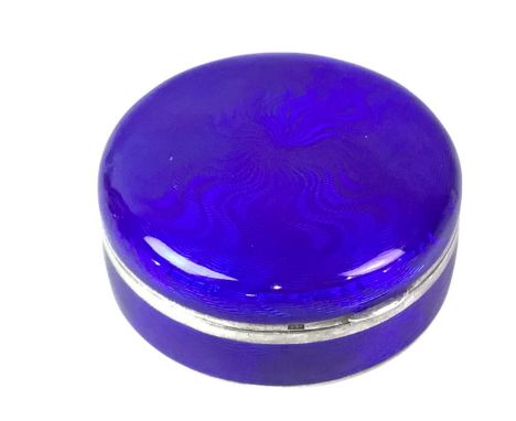 CONTINENTAL SILVER AND ENAMEL PILL BOX, EARLY / MID 20TH CENTURY of circular form with blue enamel decoration and gilt interi